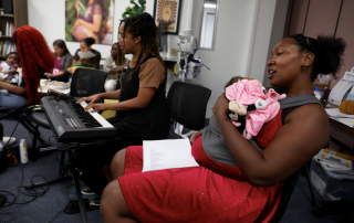 A woman sings a lullaby to her baby